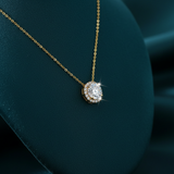 Gold diamond halo pendant necklace side angle on velvet stand