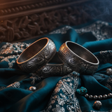 Oxidized Silver Peacock Bangle on dark teal silk fabric